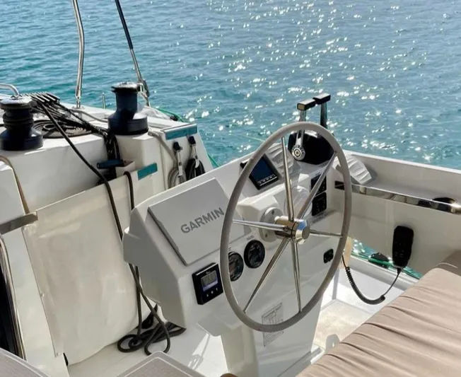 Elba 45 Yacht Photos Pics Helm of 2021 Fountaine Pajot Catamaran Elba 45 with Garmin navigation, overlooking sparkling water.