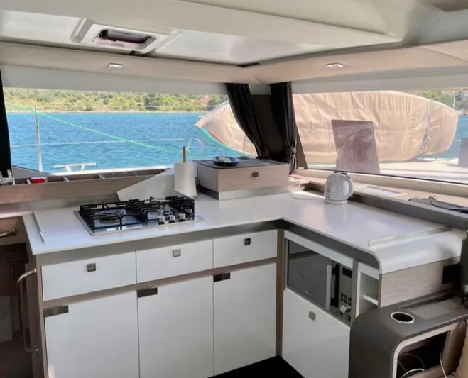 Elba 45 Yacht Photos Pics Modern kitchen interior of 2021 Fountaine Pajot Catamaran Elba 45 with ocean view.