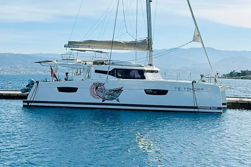Elba 45 Yacht Photos Pics 2021 Fountaine Pajot Catamaran Elba 45 docked in serene waters.