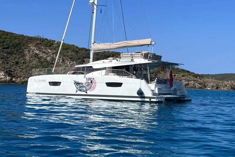 Elba 45 Yacht Photos Pics 2021 Fountaine Pajot Catamaran Elba 45 sailing in clear blue waters.