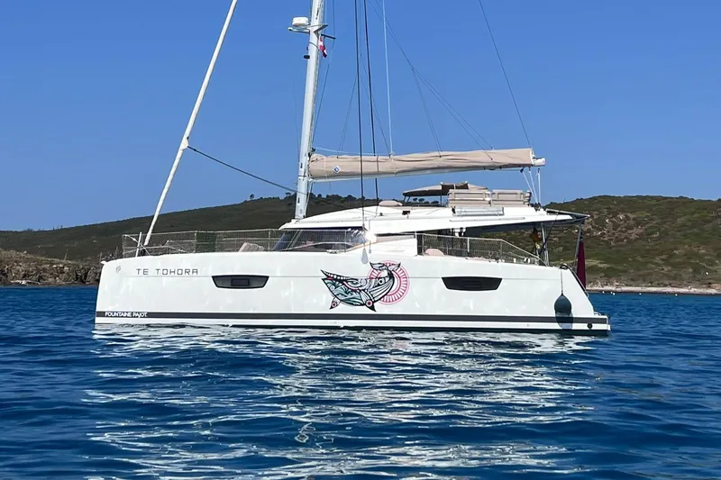 Elba 45 Yacht Photos Pics 2021 Fountaine Pajot Catamaran Elba 45 sailing in clear blue waters.