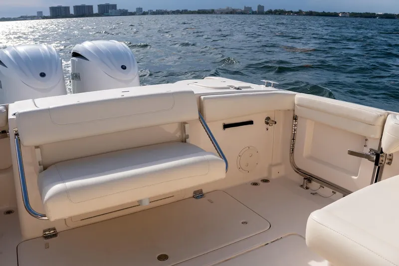  Yacht Photos Pics 2022 Grady-White Freedom 285 boat interior with seating, ocean view, and dual engines.