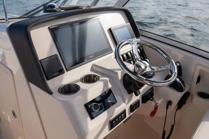 Yacht Photos Pics 2022 Grady-White Freedom 285 boat dashboard with steering wheel and electronic displays.