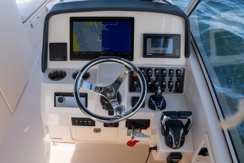  Yacht Photos Pics 2022 Grady-White Freedom 285 helm with navigation screens and controls on open water.