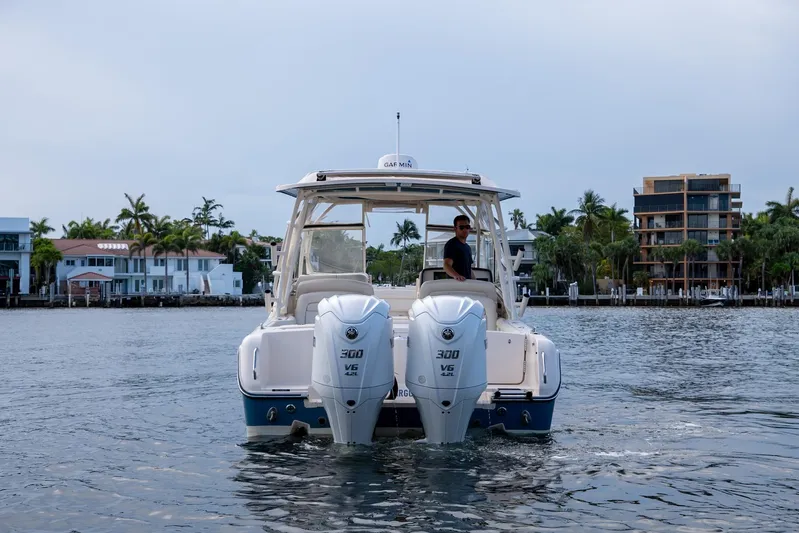  Yacht Photos Pics 2022 Grady-White Freedom 285 boat with dual engines on a calm waterway.