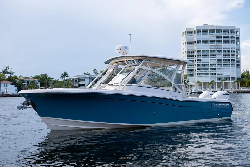  Yacht Photos Pics 2022 Grady-White Freedom 285 boat on water near modern building.