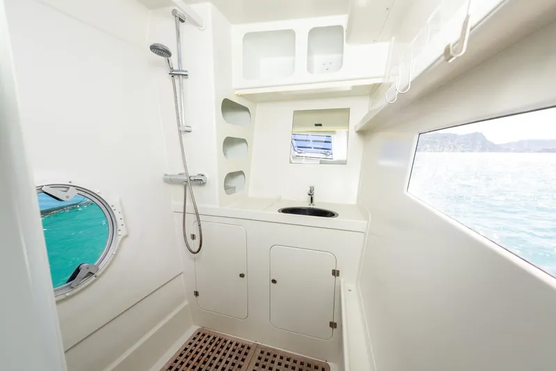 Diversion Yacht Photos Pics Modern boat bathroom with shower, sink, and ocean view, Custom Mcat 52, 2015 model.