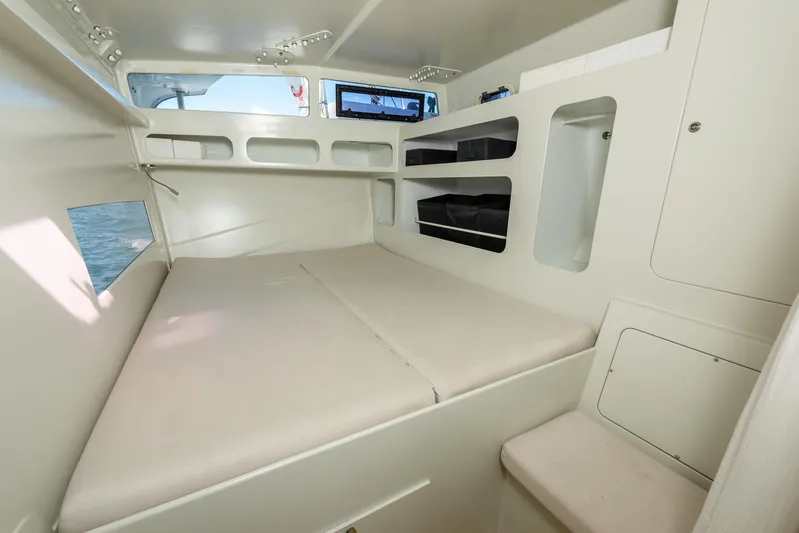 Diversion Yacht Photos Pics Interior cabin of 2015 Custom Mcat 52 with bed and storage shelves.