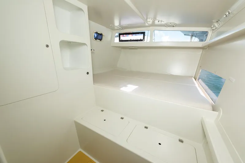 Diversion Yacht Photos Pics Interior of 2015 Custom Mcat 52 boat, featuring a minimalist white cabin design.