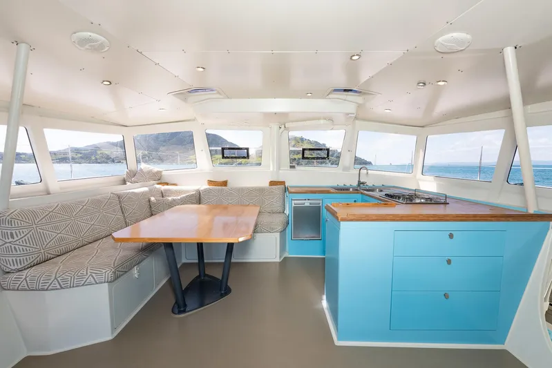 Diversion Yacht Photos Pics Spacious interior of 2015 Custom Mcat 52 catamaran with modern kitchen and seating area.