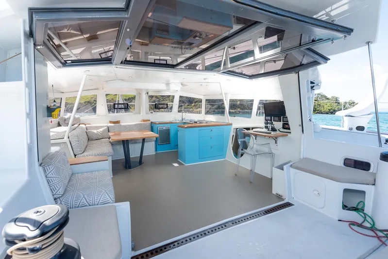 Diversion Yacht Photos Pics Spacious interior of 2015 Custom Mcat 52 catamaran with modern furnishings and ocean view.