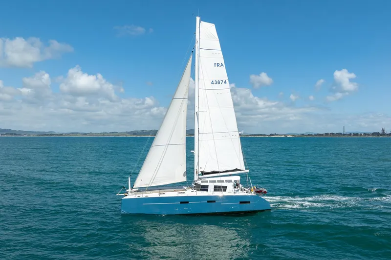 Diversion Yacht Photos Pics Sailing catamaran "Custom Mcat 52" gliding on blue ocean under clear sky, 2015 model.