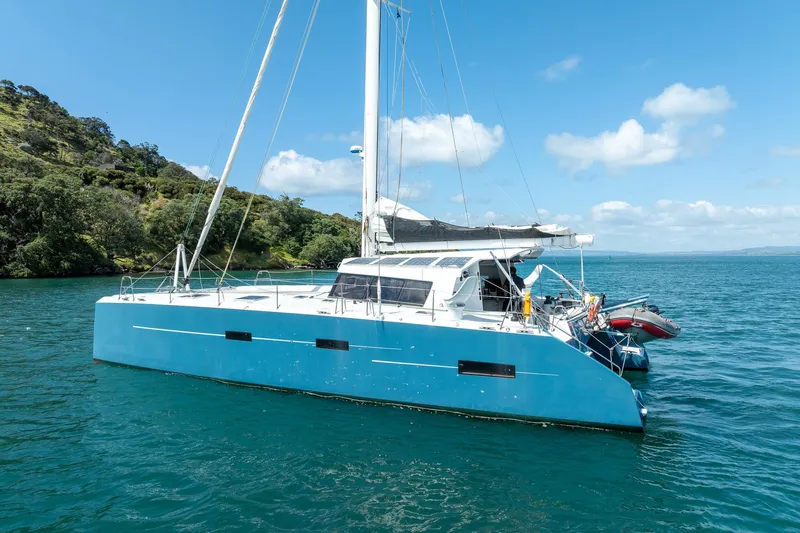 Diversion Yacht Photos Pics Custom Mcat 52 catamaran sailing on clear blue water, 2015 model, under a sunny sky.