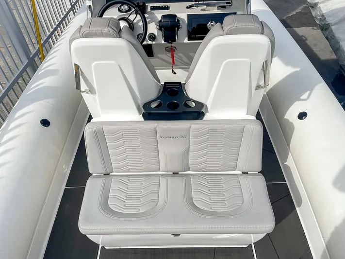  Yacht Photos Pics 2025 Ribco Venom 30 boat interior with white seating and modern dashboard.