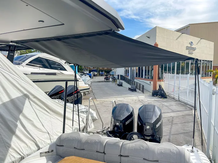  Yacht Photos Pics Ribco Venom 30 boat, 2025 model, with dual Mercury engines, docked under a canopy.