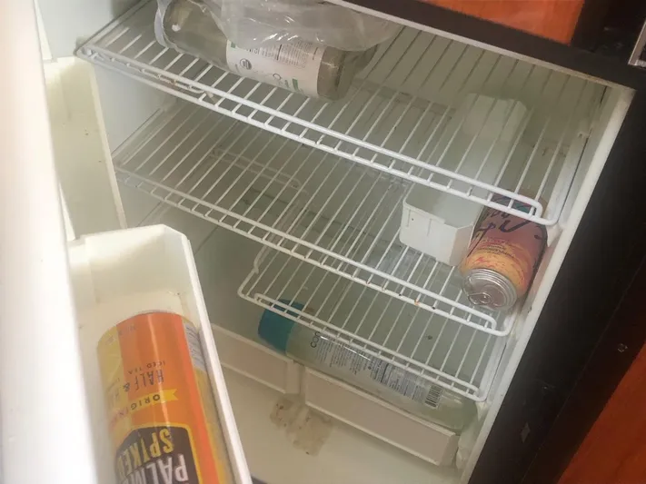 Hat Trick Yacht Photos Pics Empty refrigerator with drinks inside a 2003 Sea Ray 400 Sedan Bridge yacht.