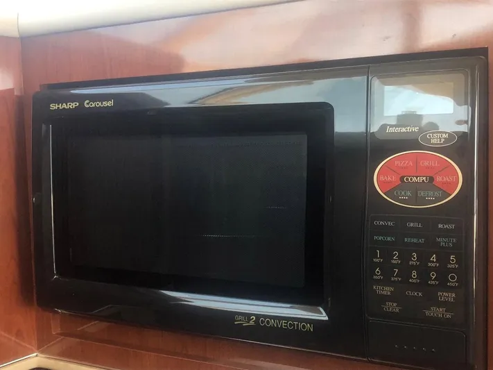 Hat Trick Yacht Photos Pics Sharp Carousel microwave in 2003 Sea Ray 400 Sedan Bridge yacht kitchen.