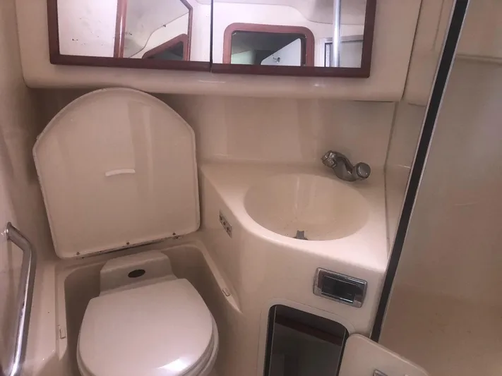 Hat Trick Yacht Photos Pics 2003 Sea Ray 400 Sedan Bridge bathroom with toilet, sink, and mirror.