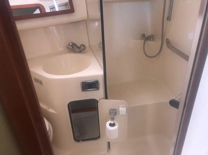 Hat Trick Yacht Photos Pics 2003 Sea Ray 400 Sedan Bridge bathroom with sink, shower, and toilet.