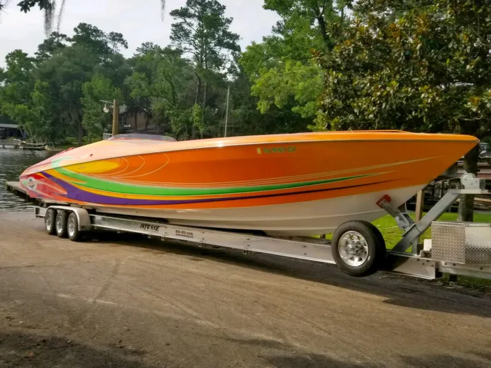  Yacht Photos Pics 2005 Outerlimits 51 Sport Yacht with vibrant orange and green design on a trailer.