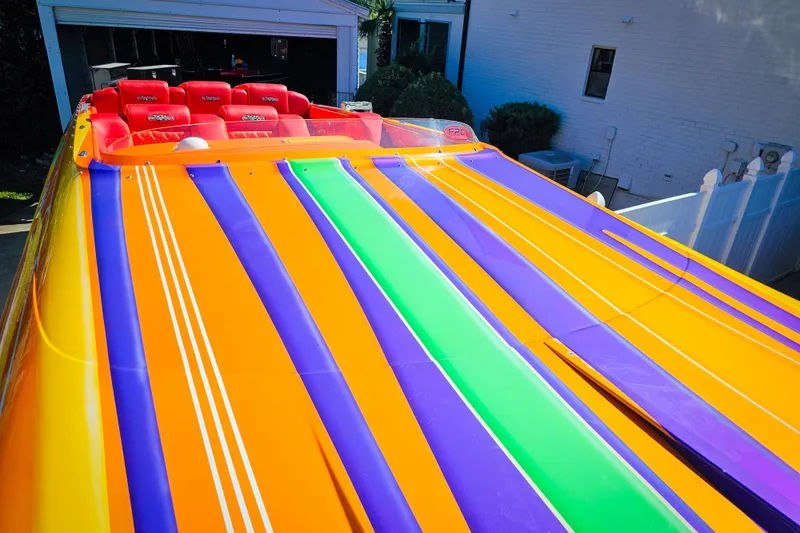  Yacht Photos Pics Colorful 2005 Outerlimits 51 Sport Yacht with vibrant stripes and red seats.