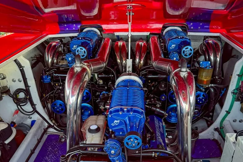  Yacht Photos Pics Engine compartment of a 2005 Outerlimits 51 Sport Yacht with blue components and chrome pipes.