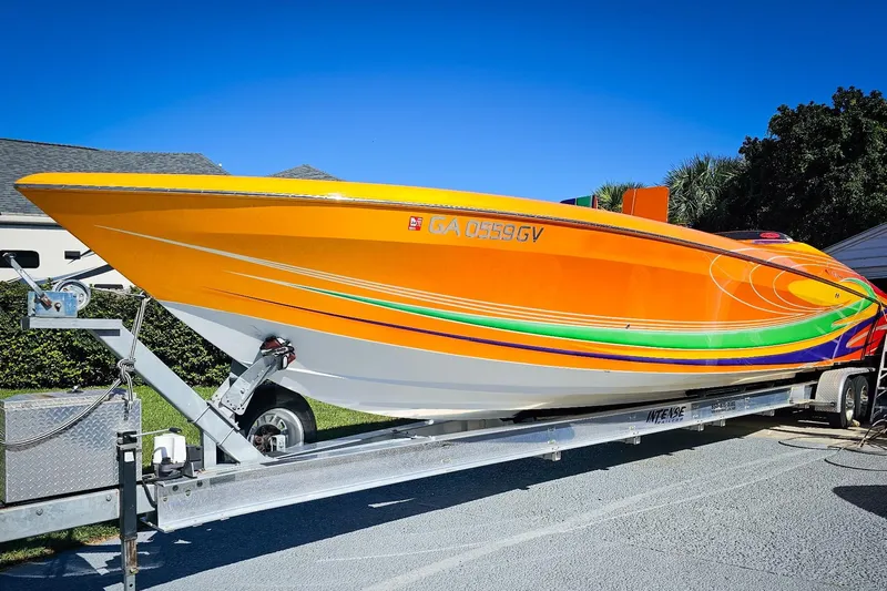 Yacht Photos Pics 2005 Outerlimits 51 Sport Yacht with vibrant orange and green design on a trailer.