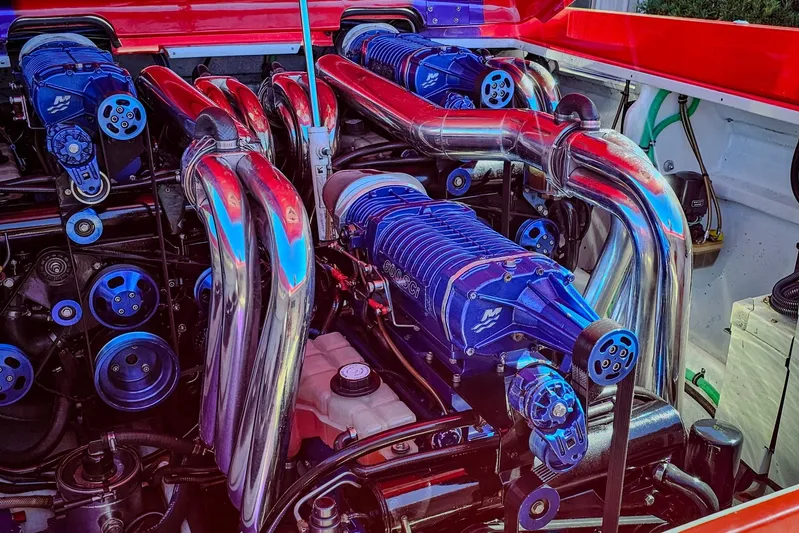  Yacht Photos Pics Engine of a 2005 Outerlimits 51 Sport Yacht with polished components and blue accents.