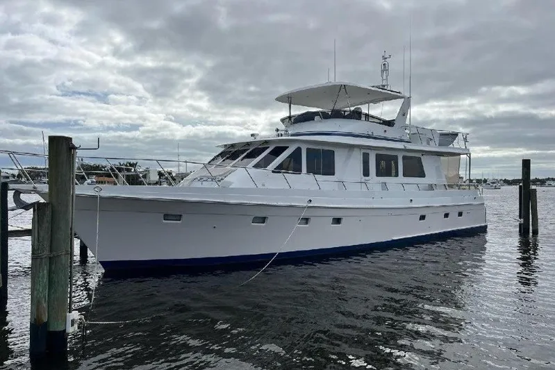 Endless Summer Yacht Photos Pics 2008 Offshore Yachts 62 Flushdeck, white luxury yacht docked on a cloudy day.