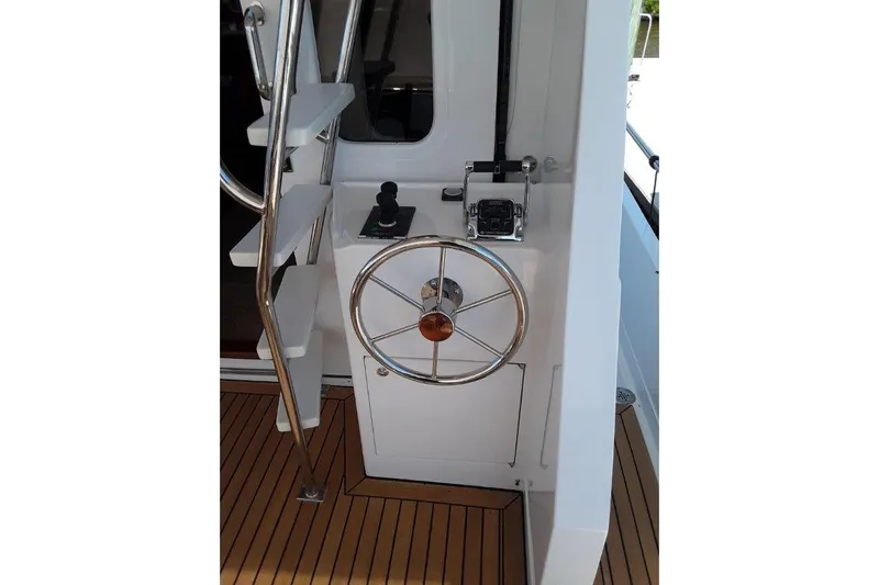 Endless Summer Yacht Photos Pics Cockpit helm station with stainless steel wheel and controls.