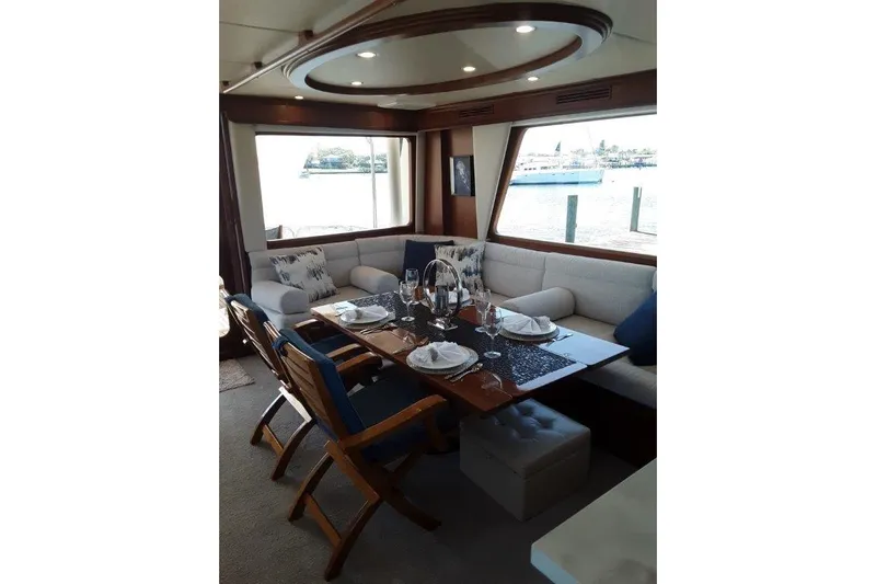 Endless Summer Yacht Photos Pics Luxurious interior of 2008 Offshore Yachts 62 Flushdeck with elegant dining setup.