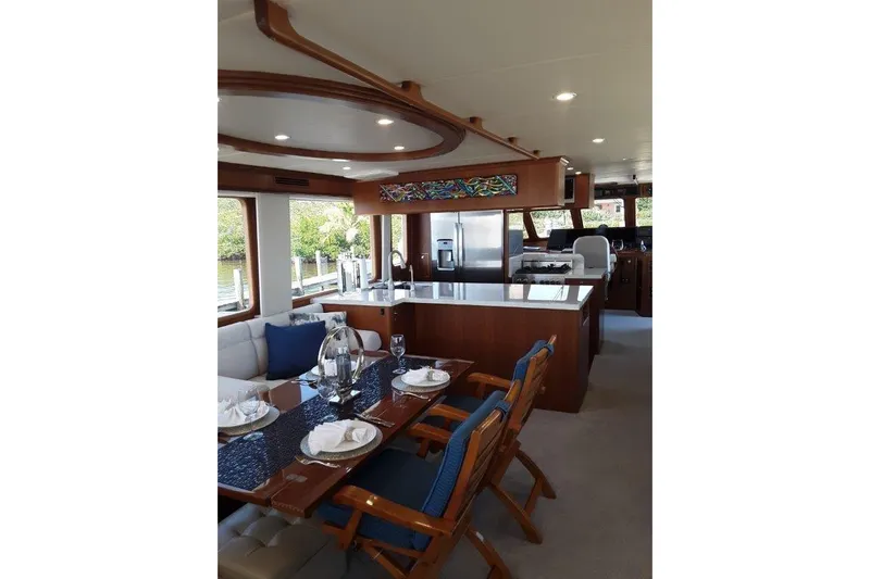 Endless Summer Yacht Photos Pics Luxurious interior of 2008 Offshore Yachts 62 Flushdeck, featuring elegant dining and kitchen area.