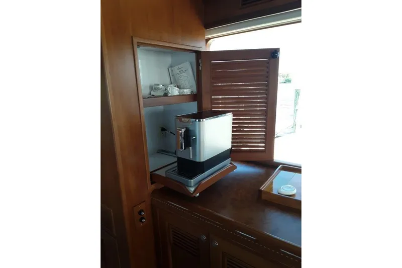 Endless Summer Yacht Photos Pics Coffee machine in wooden cabinet aboard 2008 Offshore Yachts 62 Flushdeck.