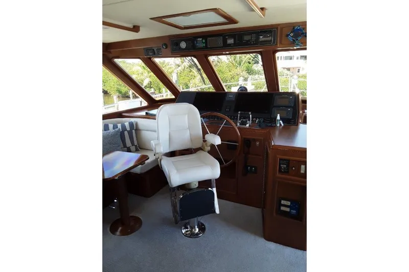 Endless Summer Yacht Photos Pics Interior helm of 2008 Offshore Yachts 62 Flushdeck, featuring captain's chair and navigation controls.