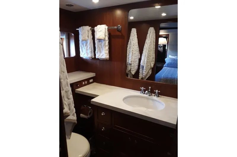 Endless Summer Yacht Photos Pics Master bathroom, featuring elegant wood cabinetry and modern fixtures.