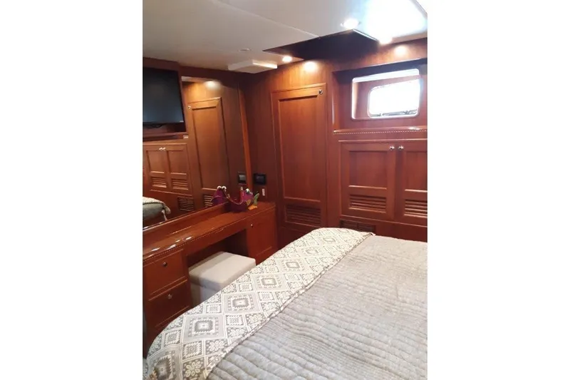 Endless Summer Yacht Photos Pics Luxurious 2008 Offshore Yachts 62 Flushdeck cabin with elegant wood interior and cozy bedding.