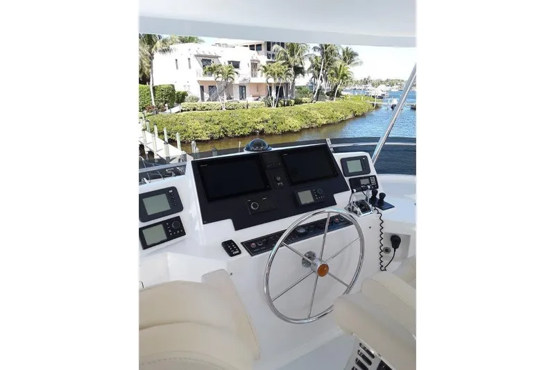 Endless Summer Yacht Photos Pics Helm of 2008 Offshore Yachts 62 Flushdeck with navigation equipment and waterfront view.