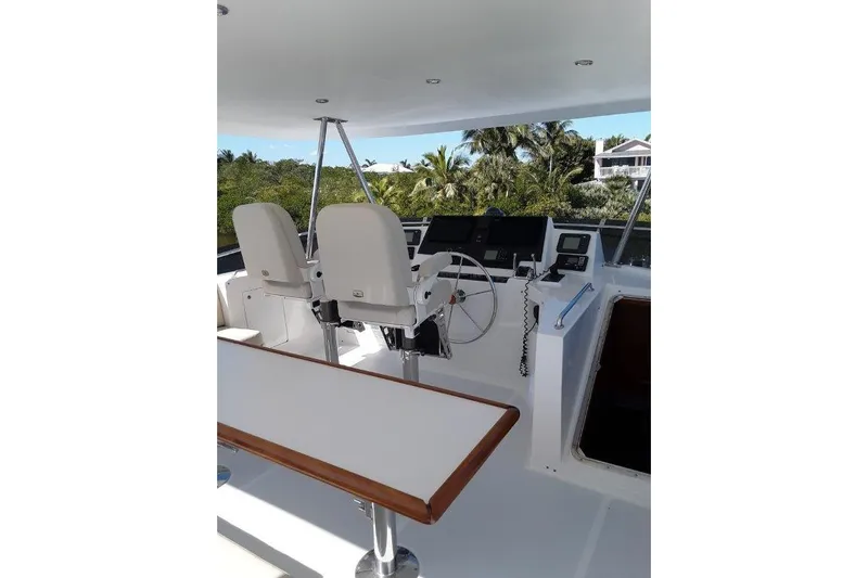 Endless Summer Yacht Photos Pics Flybridge helm with dual seats and navigation equipment.