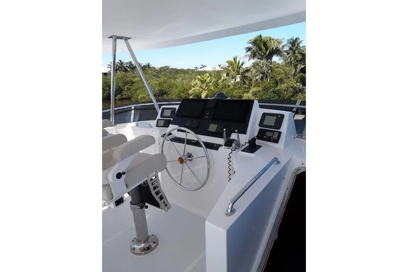 Endless Summer Yacht Photos Pics Flybridge Helm of 2008 Offshore Yachts 62 Flushdeck with navigation equipment and steering wheel.