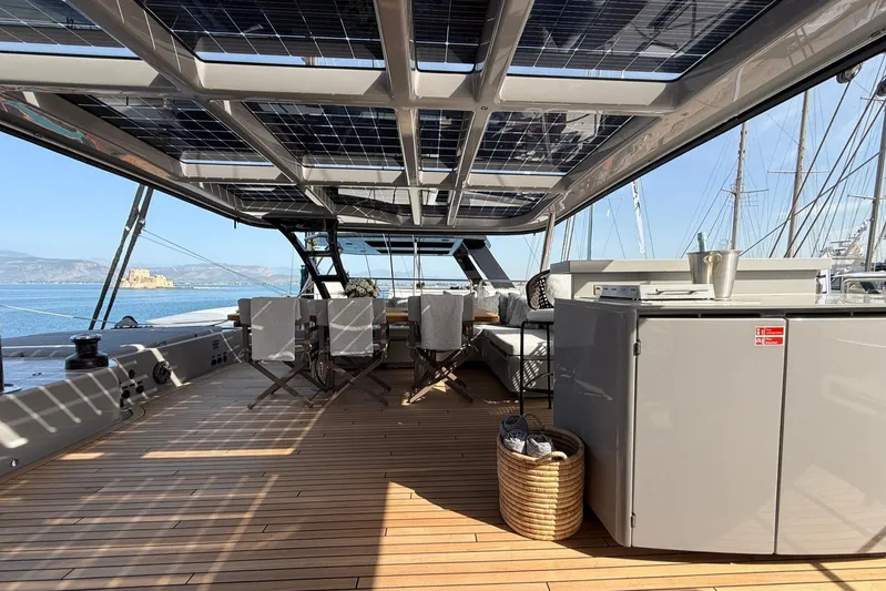 Serenity Yacht Photos Pics Luxurious Sunreef 60 yacht deck with solar panels, elegant seating, and ocean view, 2024 model.