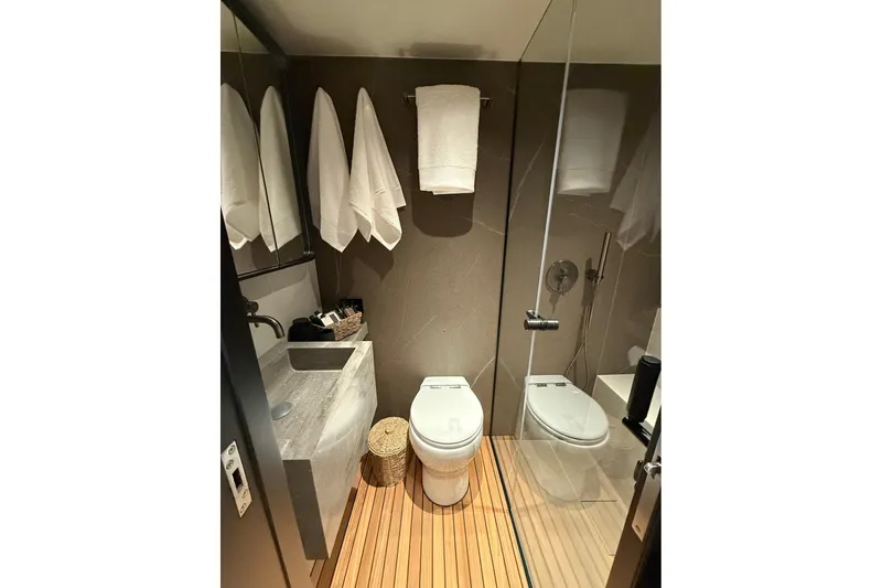 Serenity Yacht Photos Pics Luxurious bathroom in 2024 Sunreef 60 yacht with modern fixtures and elegant design.