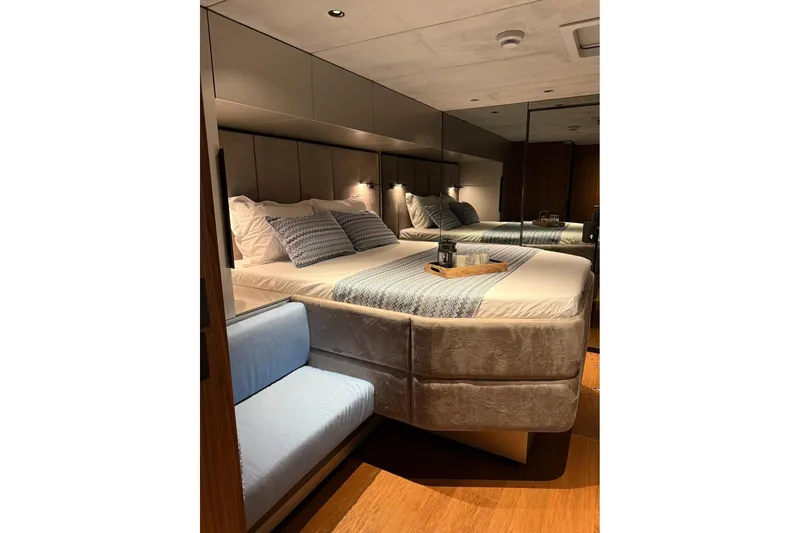 Serenity Yacht Photos Pics Luxurious bedroom interior of 2024 Sunreef 60 yacht with elegant bedding and modern design.