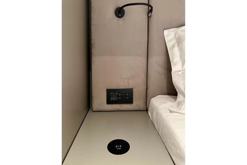 Serenity Yacht Photos Pics Luxurious Sunreef 60 yacht interior, featuring modern electrical outlets and wireless charging station, 2024 model.