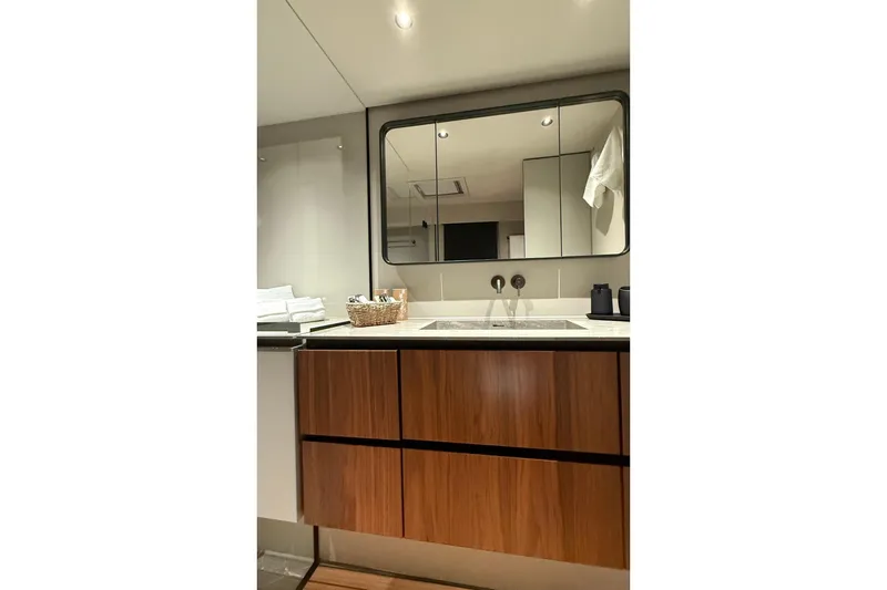 Serenity Yacht Photos Pics Luxurious bathroom interior of 2024 Sunreef 60 yacht with modern fixtures and wooden cabinetry.