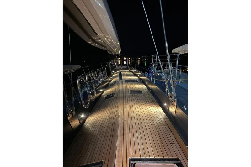 Serenity Yacht Photos Pics Illuminated deck of 2024 Sunreef 60 yacht at night, showcasing sleek design.