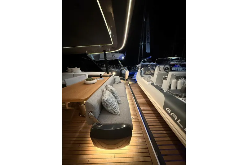 Serenity Yacht Photos Pics Luxurious 2024 Sunreef 60 yacht deck with elegant seating and ambient lighting at night.