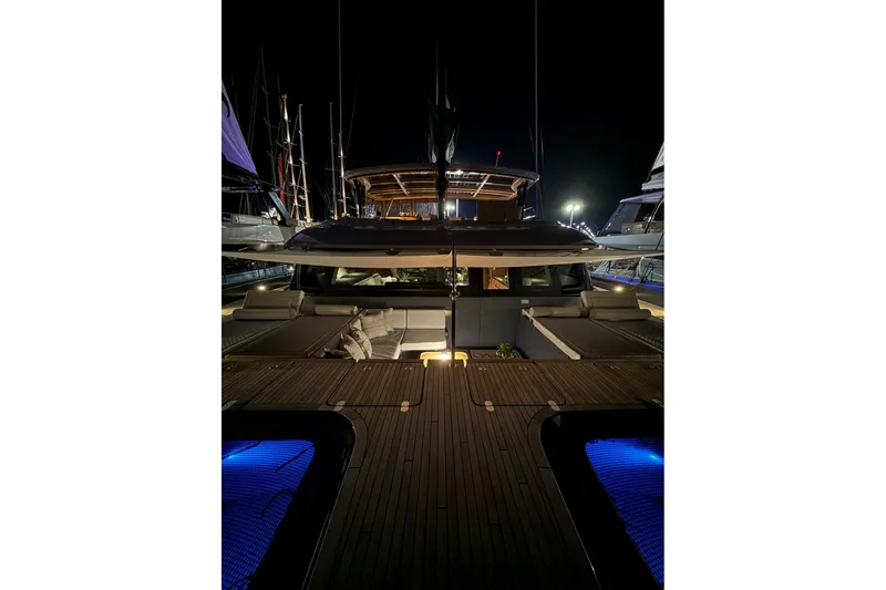 Serenity Yacht Photos Pics Luxurious 2024 Sunreef 60 yacht illuminated at night, showcasing elegant design and spacious deck.