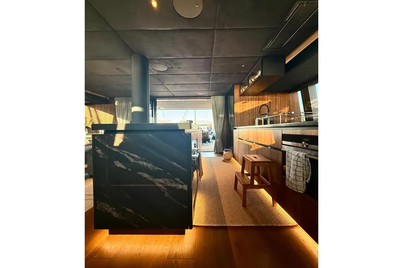 Serenity Yacht Photos Pics Luxurious interior of 2024 Sunreef 60 yacht with modern kitchen design and elegant finishes.