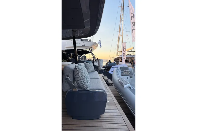 Serenity Yacht Photos Pics 2024 Sunreef 60 yacht deck with modern seating and nearby inflatable boat.