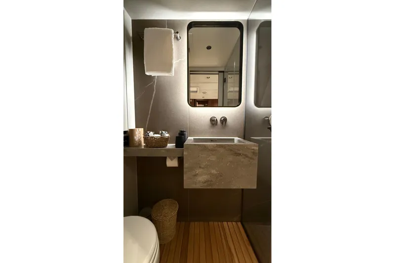 Serenity Yacht Photos Pics Luxurious bathroom interior of 2024 Sunreef 60 yacht with modern sink and mirror.